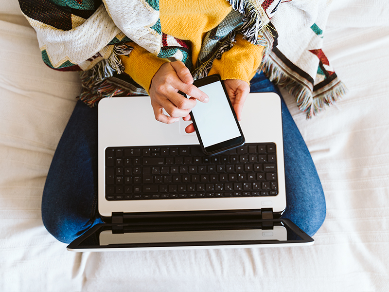 Person using phone and computer