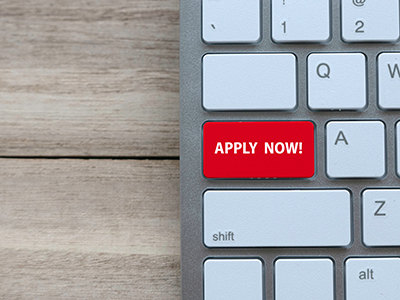 Keyboard with a red key labeled 'apply now'