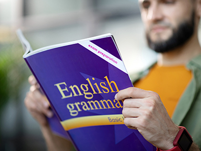 Person Reviewing an English Grammar Book